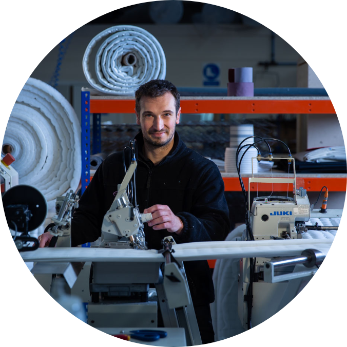 Man in blue overalls working on machine