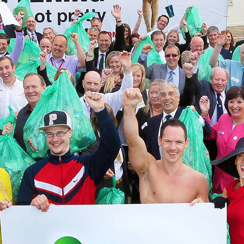 A large group of people outside supporting an anti littering initiative 