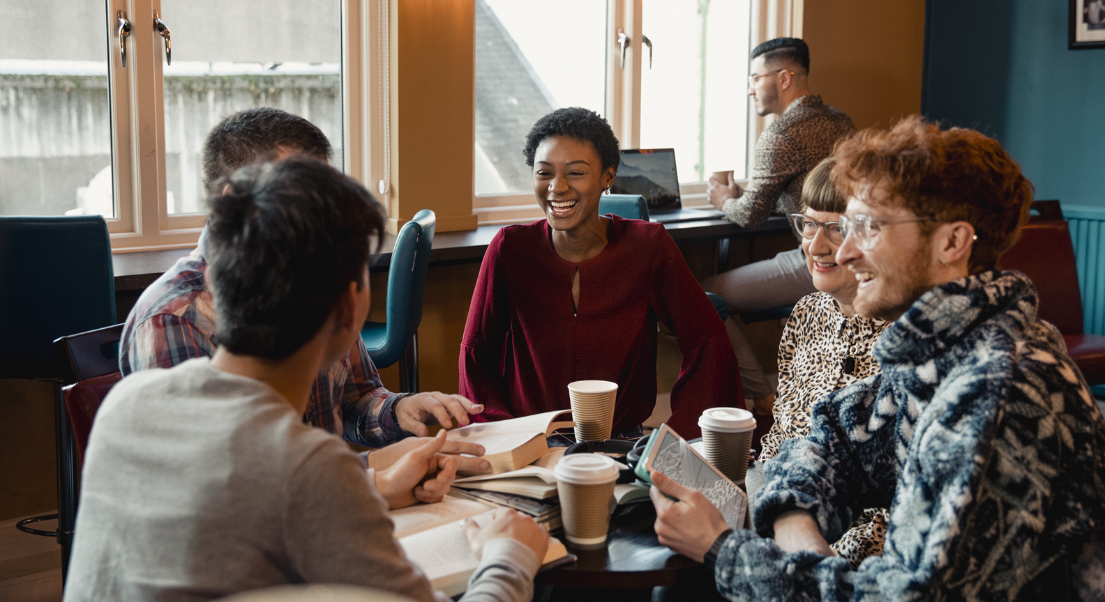 A group of people at a community group meeting around a table