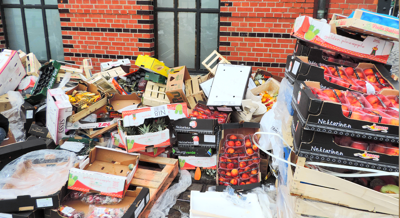 Discarded food waste in packaging outside a shop