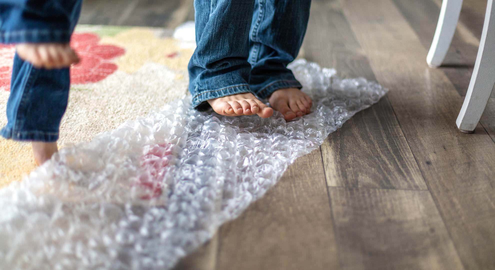 Two young people standing on bubble wrap