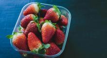 A plastic tub featuring strawberries 