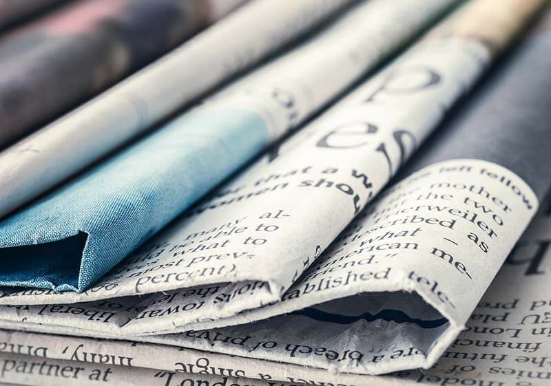 A pile of different newspapers