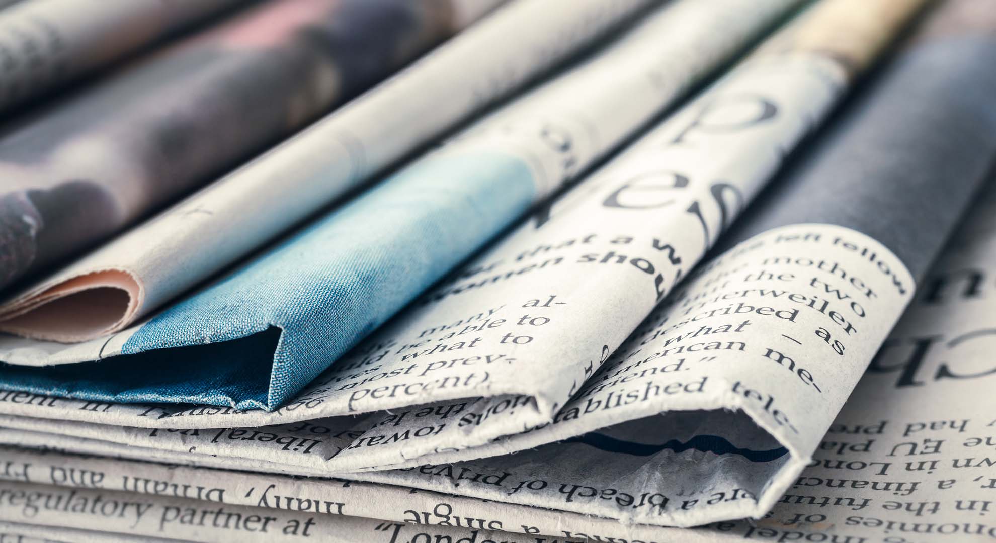 A pile of different newspapers