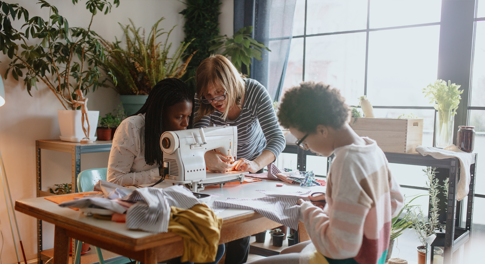 A group of people working around a sewing machine