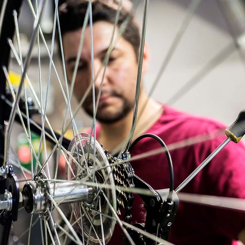 Photo of a person repairing a bike