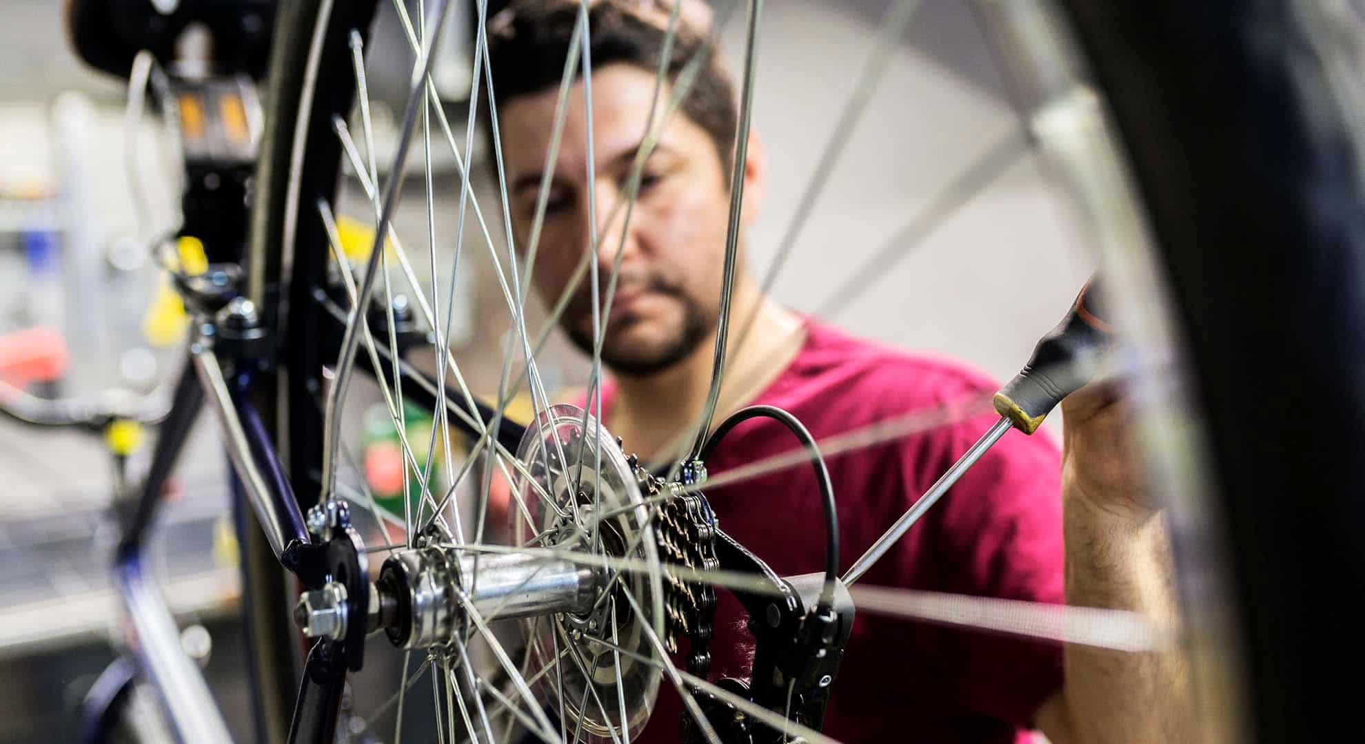 Photo of a person repairing a bike