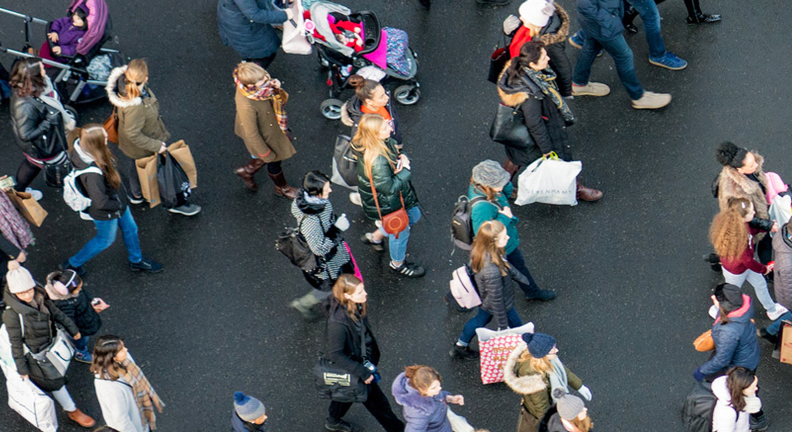 Large group of people walking on a road