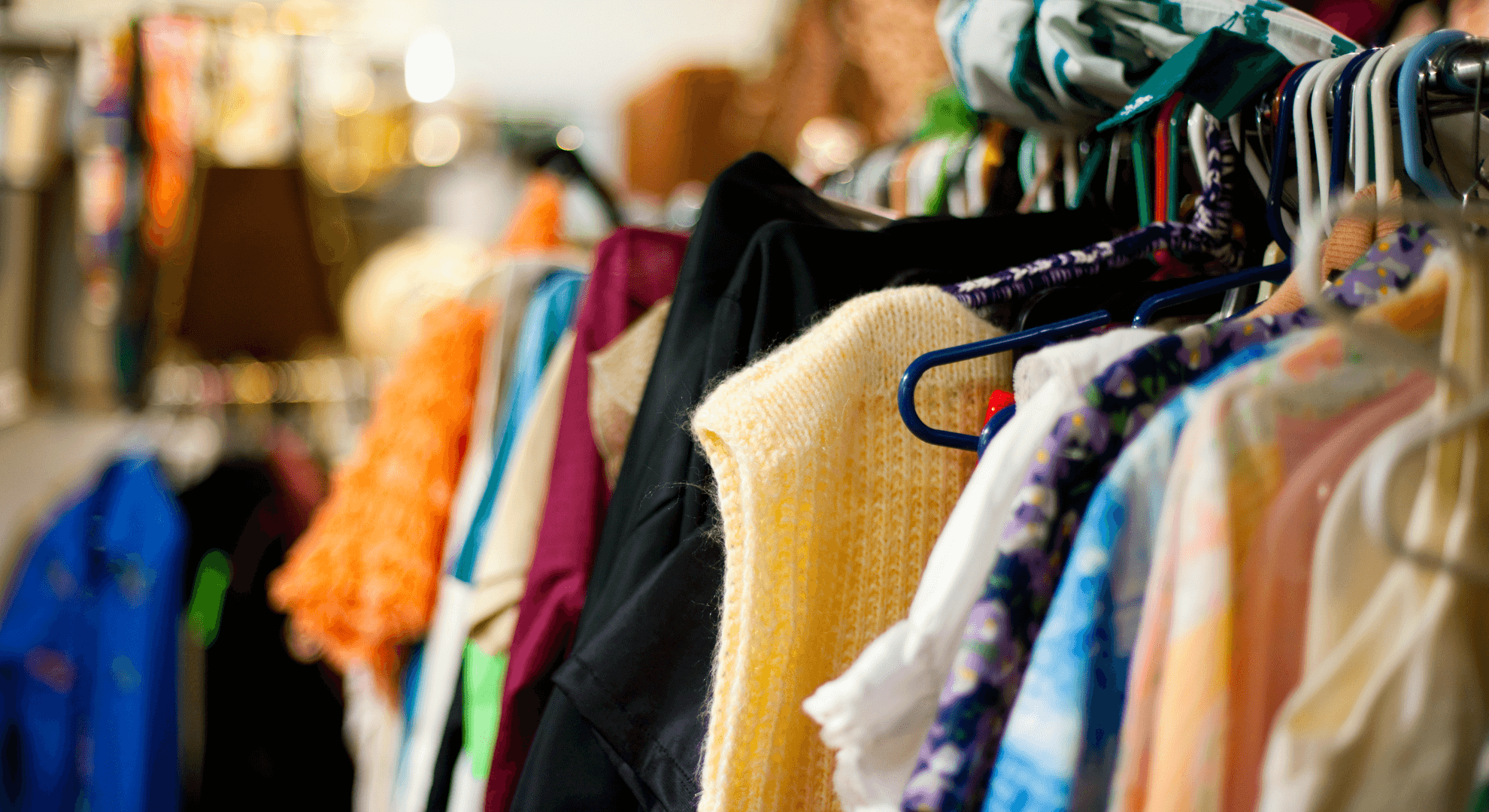 A selection of clothes hanging on rails