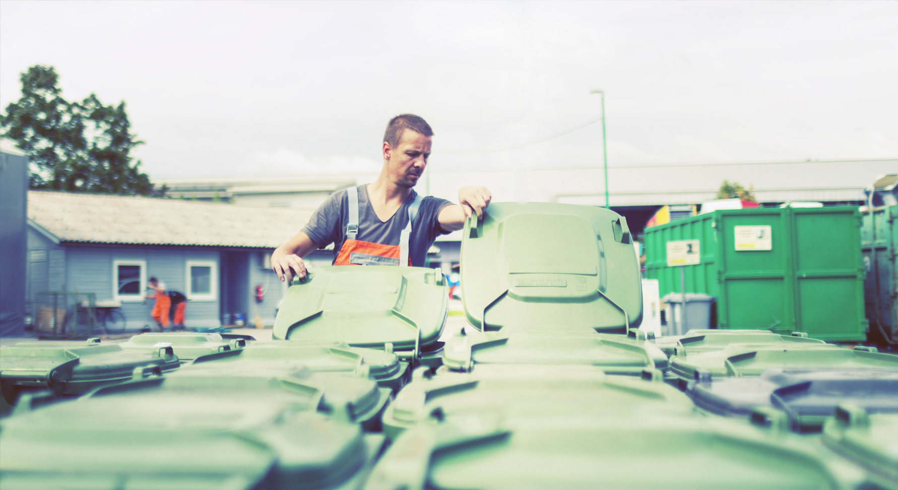 A man looking at a large number of bins, wondering what's inside them