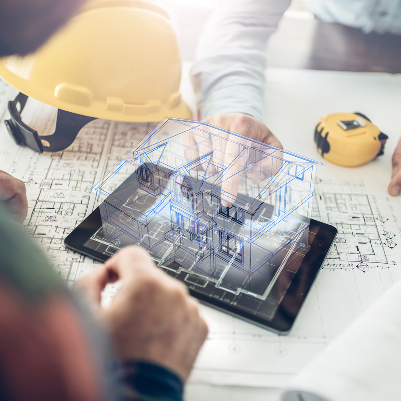 Conceptual image of a house design process, with plans, tools and people working on the design