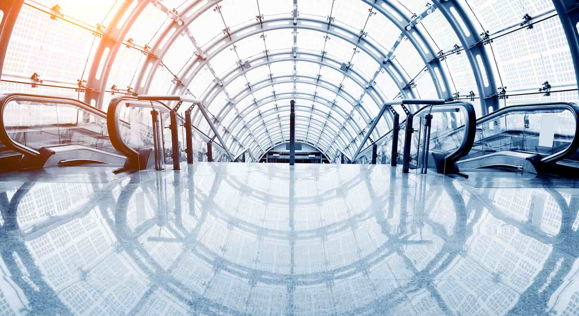 View of the top of an escalator with the windows creating concentric circles