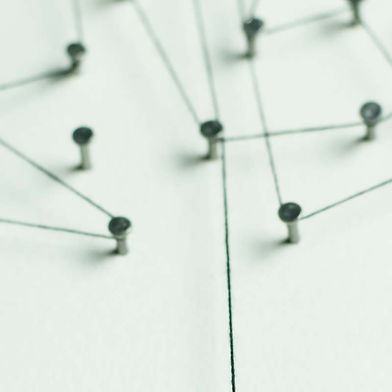 Nails on a light green board with string connecting them