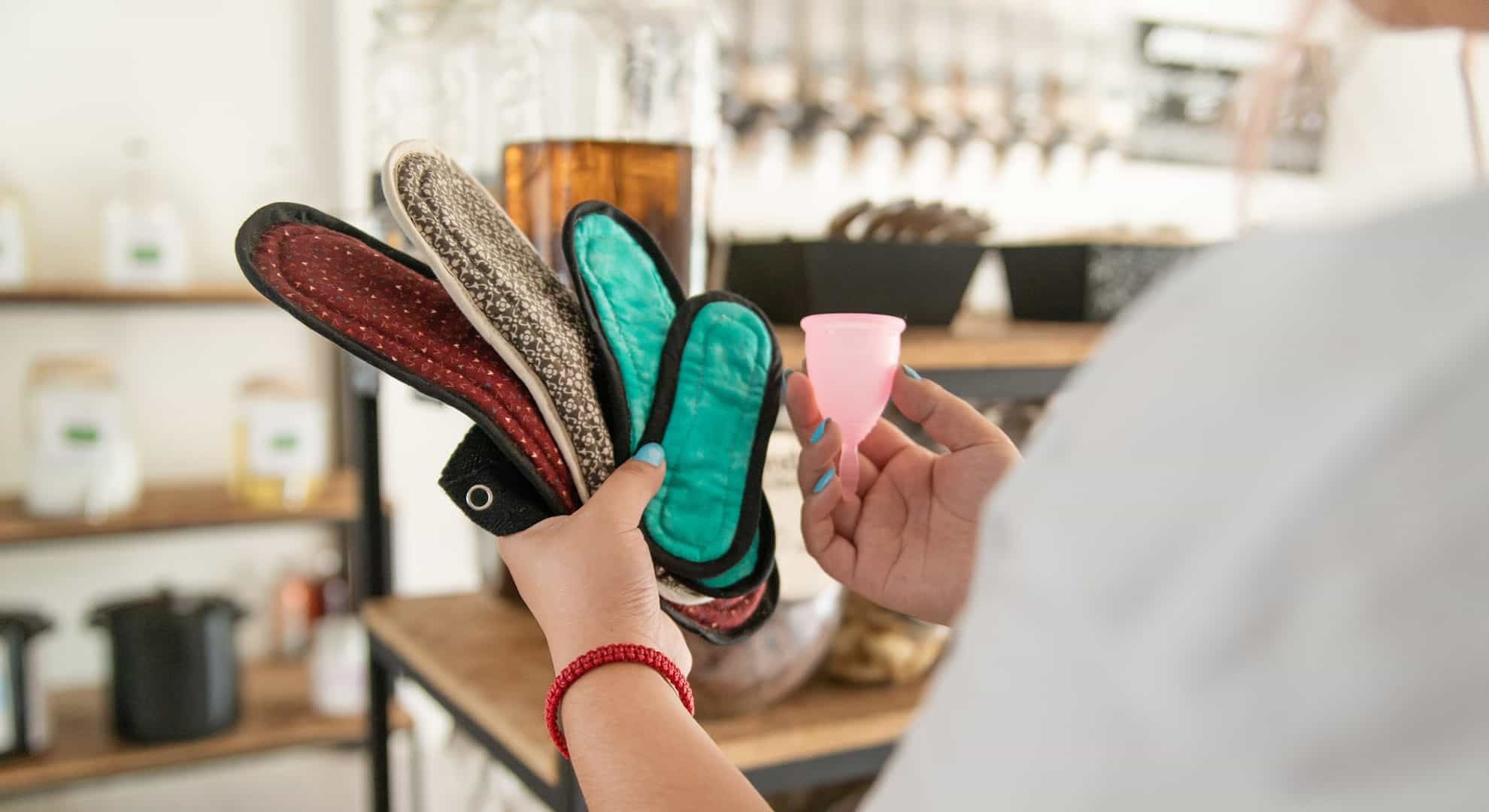 a person holding a selection of reusable period products