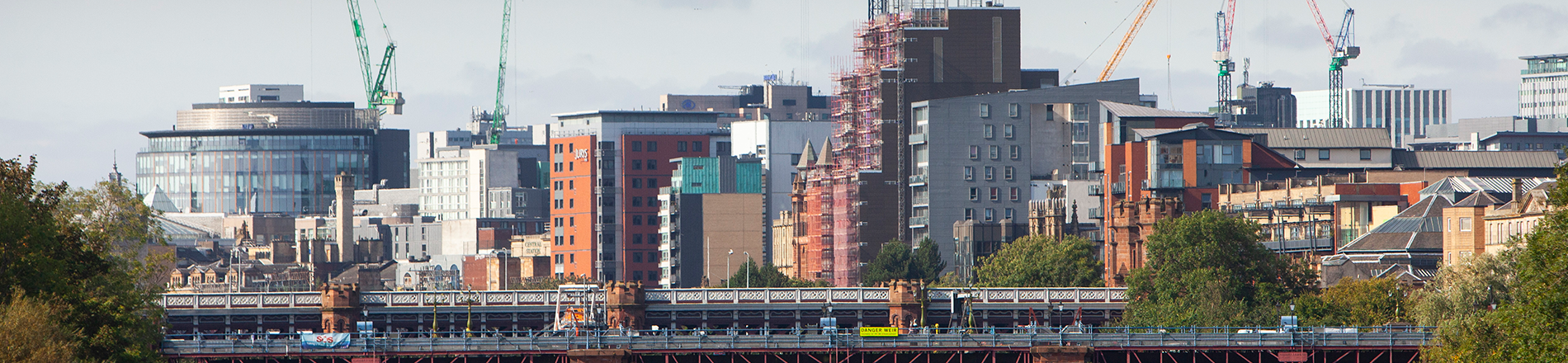 City skyline with construction cranes