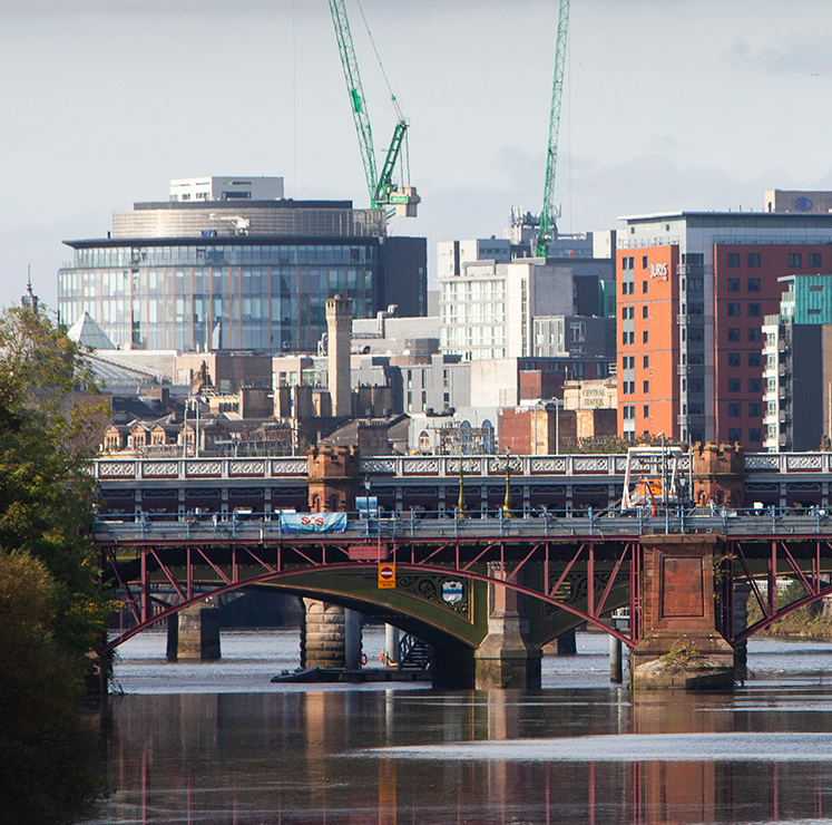 City skyline with construction cranes